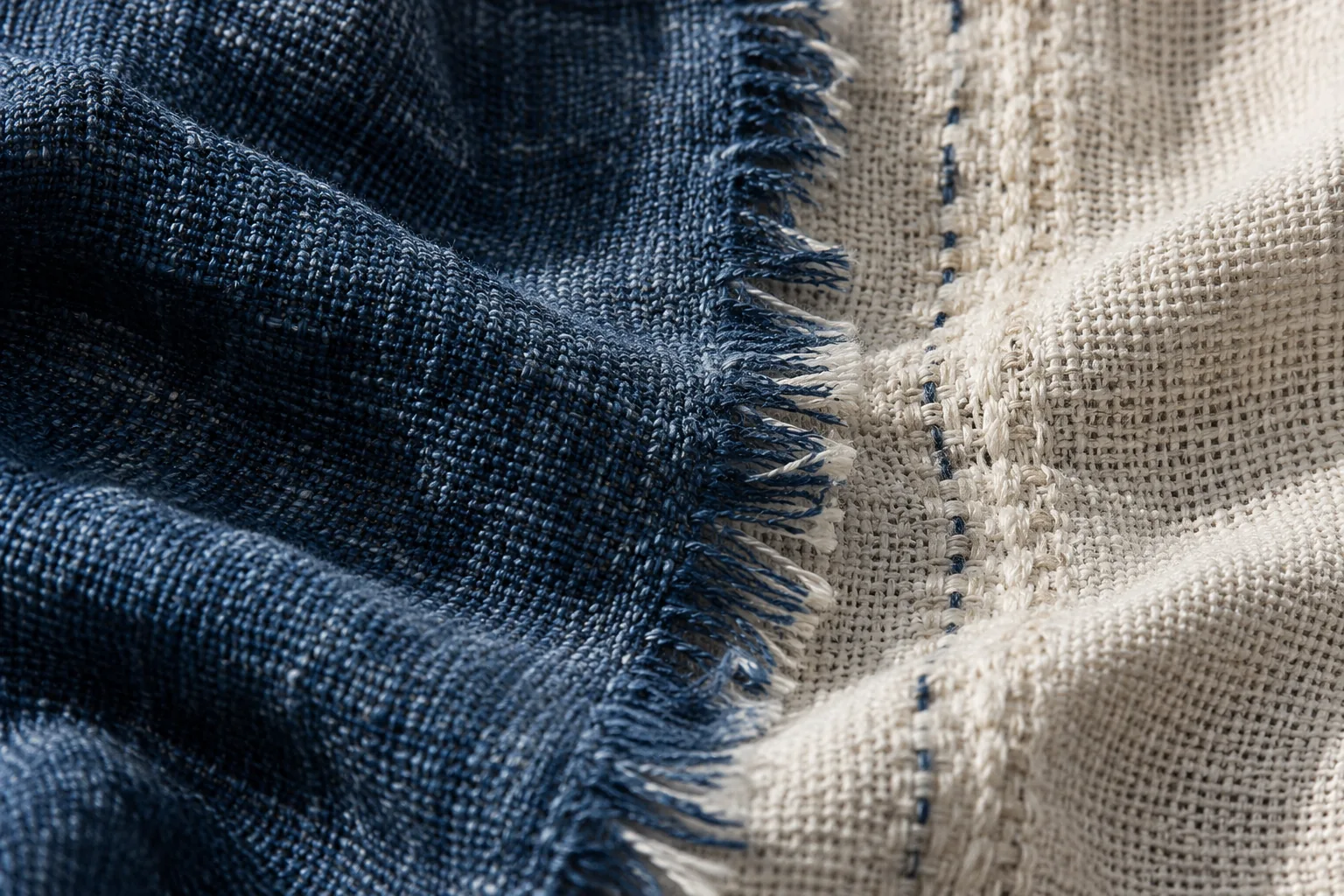 Original concept macro image of an indigo woven edge meeting an ecru textile